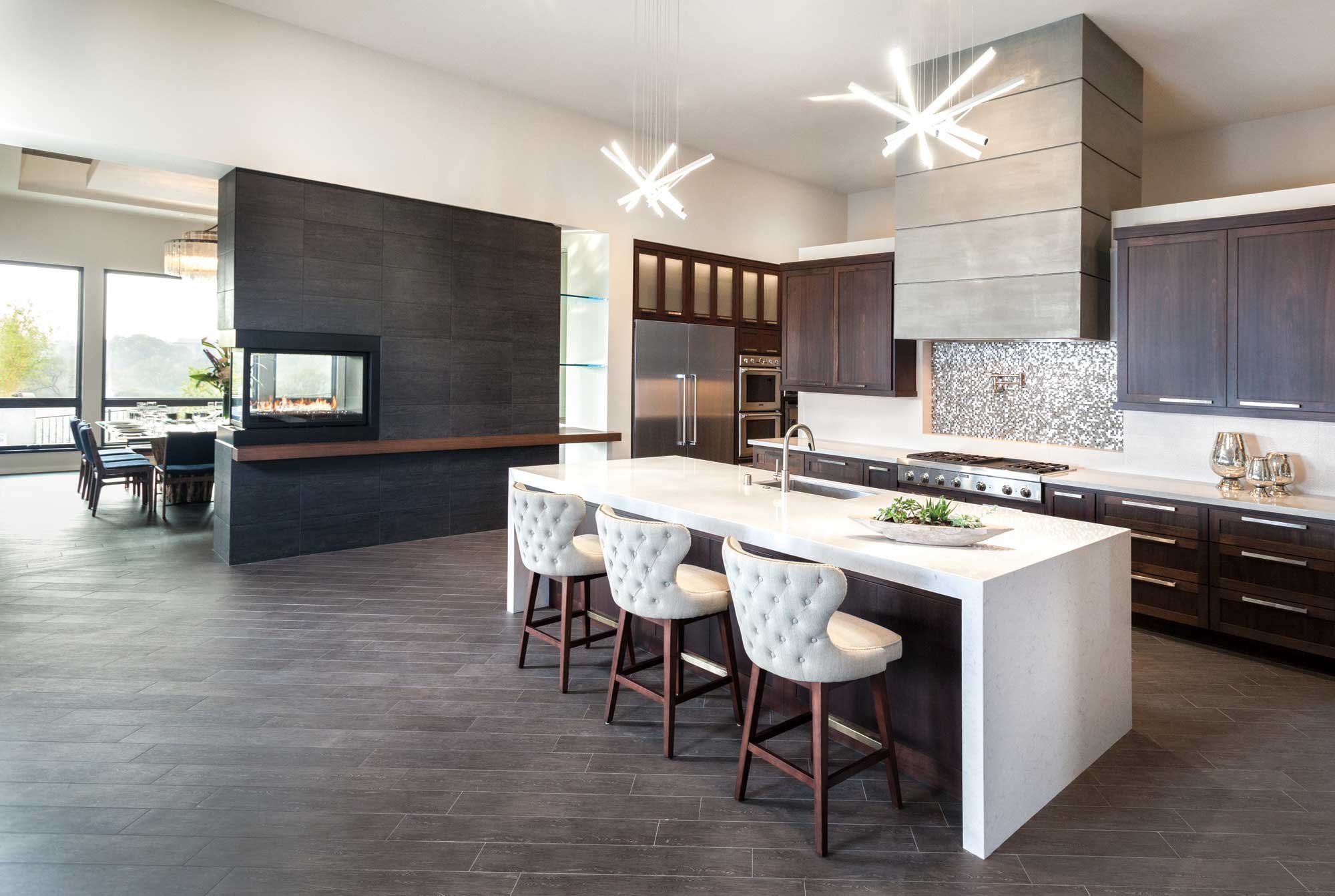 modern kitchen with island seating and pass through fireplace